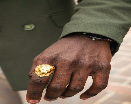 A person polishing a gold ring